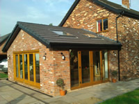 Brick sun room with oak bi-fold doors