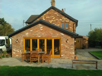 Brick sun room with oak bi-fold doors