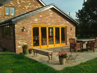 Brick sun room with oak bi-fold doors